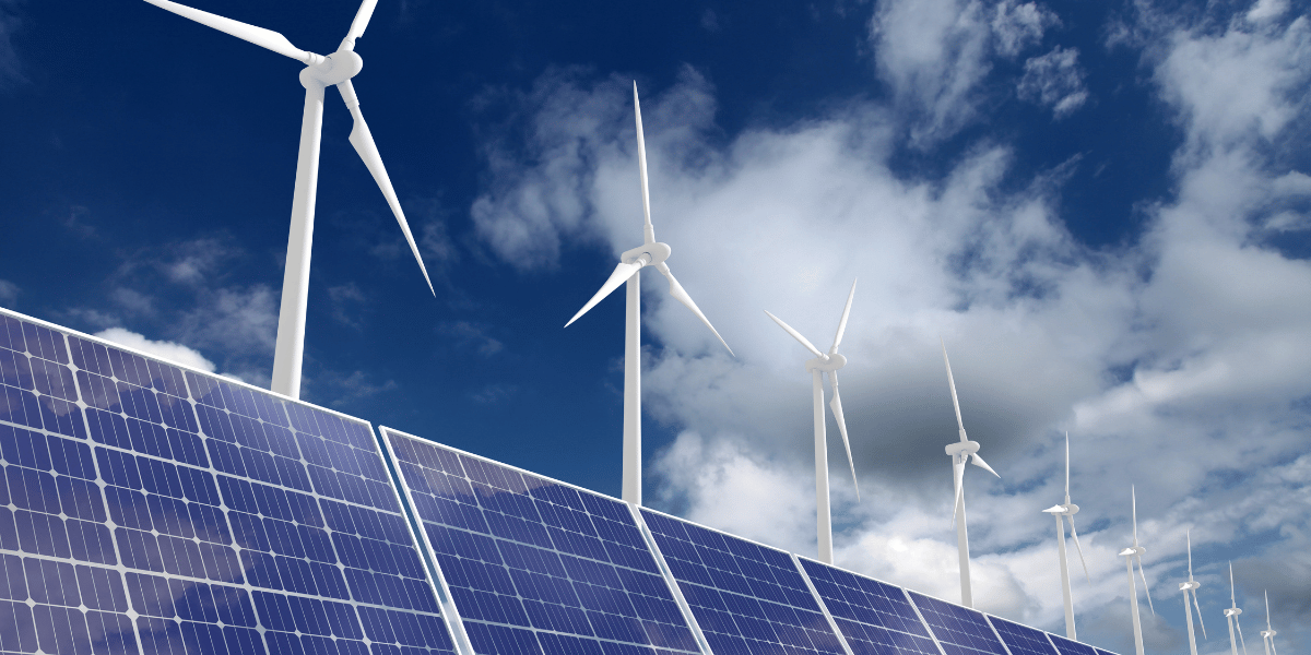 wind turbines and solar panels against a blue sky backdrop